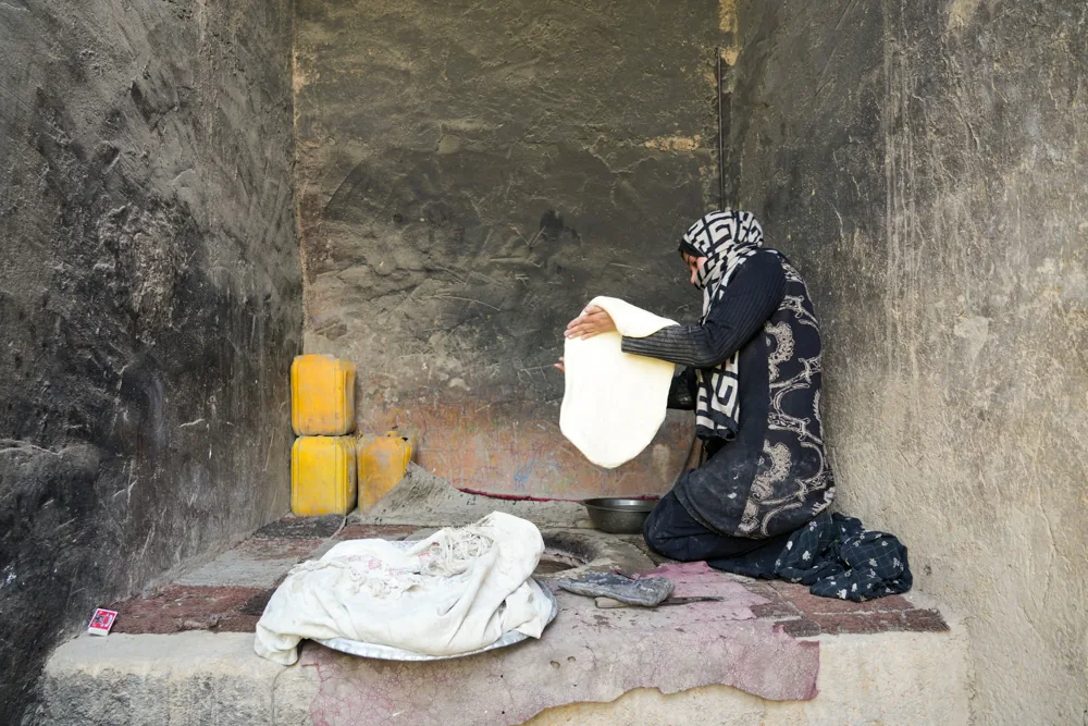 A woman prepares bread dough in a home bakery
